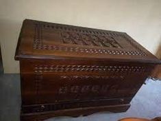 an old wooden box sitting on the floor