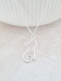 Enjoy this necklace for any cat lovers and add a touch of personalisation with this quirky personalised csat outline necklace.  A cute reminder of the joy and happiness your feline friend brings into your life. Choose to have the necklace with or without the initial. The cat measures 22mm x 9mm and the stainless initial disc measures 10mm in diameter. There are three fonts to choose from. The necklace will arrive in a bag ready for giving. This item ships from the UK within 1 working day. Cute Cat Necklace, Silver Cat Pendant, Cat Necklace Silver, Necklace Cat, Cat Pendant Necklace, Cat Bracelet, Cat Lady Gift, Cat Pendant, Silver Cat