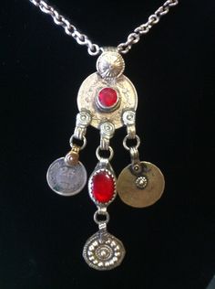 "This is a really great piece. The pendant consists of old coins teamed with a couple of red synthetic stones with the addition of patterned medallions & is suspended on a handmade chain with a \"S\" hook closure. This is a really aesthetically pleasing piece....a joy for the eye!"