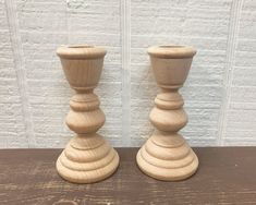 two wooden candlesticks sitting on top of a table