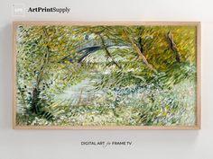 a painting hanging on the wall above a wooden frame with an image of trees and water