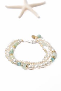 The Serenity Collection is beloved classic line from Anne Vaughan Designs. Featuring a soft colorway, this bracelet is ideal for pairing with other items from the collection. Sterling Silver (lead and nickel free) Freshwater Pearl, Amazonite, Aquamarine 7.5-8.5", adjustable with sterling silver lobster claw clasp We hand select our natural materials, thus there may be slight variations in color and/or size that will not detract from the overall aesthetic Our unique handcrafted designer jewelry f Elegant Double Strand Gemstone Beads Bracelets, Elegant Double Strand Bracelets With Gemstone Beads, Elegant Double Strand Natural Stones Bracelets, Floyd Va, Multistrand Bracelet, Silver Gold Earrings, Silver Gold Necklace, Multi Strand Bracelet, Pearl Design