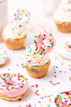 cupcakes with frosting and sprinkles on a table