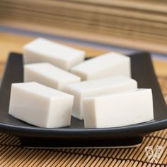 several cubes of white soap on a black plate