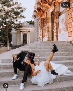 a bride and groom are sitting on the stairs