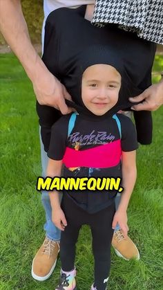 a man holding a small child in his arms with the words mannequin on it