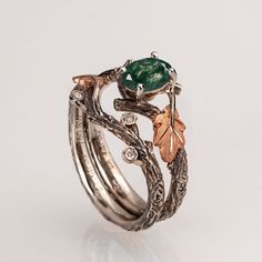 "A handmade 14k twig and leaf ring made in two gold colors and set with a natural, high-quality moss agate of your choosing and three small diamonds. The grooves in the band are plated with black rhodium which emphasizes the texture. if you prefer not to apply the black rhodium that is fine. I can also use white, rose or yellow gold for the band and the leaves for the same price. The ring in the pictures is set with a 7mmX5mm oval-shaped moss agate but can be set with any other stone, please contact me for a quote. If you are looking at this ring then you are probably looking for something special, something different. The engagement rings I design are made of 100% recycled gold and non-conflict diamonds of high quality. After I am sure you have seen a huge variety of engagement rings I am Twig Engagement Ring, Cute Engagement Rings, Fantasy Wedding, Oak Leaf, Leaf Ring, Fancy Jewelry, Pretty Rings, Black Rhodium, Fantasy Jewelry