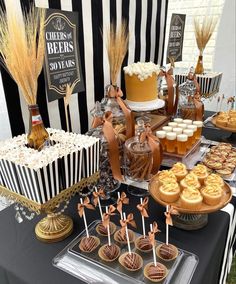 a table topped with lots of desserts next to a black and white striped wall