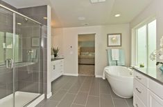 a bathroom with a large tub and walk in shower