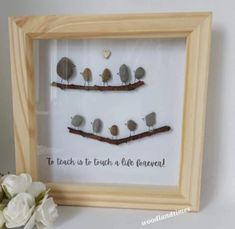 there is a framed picture with some birds on the branch and words written in it