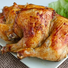 a close up of a chicken on a plate with lettuce