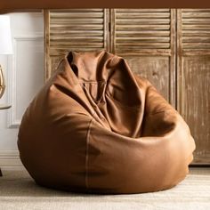 a large brown bean bag sitting on top of a floor