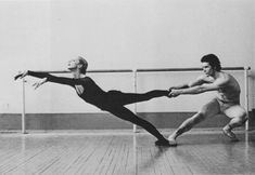 two men in black and white dance on the floor