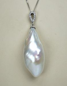 Gorgeous vintage solid 18 carat white gold and huge Baroque pearl diamond pendant ! Absolutely spectacular piece!  Measurements: pearl length 3,3cm (1,29") by width at widest part 1,4cm (0,55")  12 diamonds 1,5mm (0,06")  chain length 45cm (17,71")  total weight 8,2 grams Pendant is marked with mark 750 for 18 carat gold. Chain is marked also for 18ct gold.  Condition of the pendant is very good. No damage and scratches on the pearl, some natural imperfections. Diamond colorless with VS1 clarity Luxury Silver Teardrop Pearl Necklace, Silver Briolette Pearl Necklace For Formal Occasions, Formal Pear-shaped Pearl Necklace, Elegant Pearl Necklace With Large Pendant, Formal Pear-shaped Pearl Pendant Necklace, Formal Silver Pear-shaped Pearl Necklace, Silver Pear-shaped Pearl Necklace For Anniversary, Pear-shaped Silver Pearl Necklace For Formal Occasions, Pearl Diamond Pendant