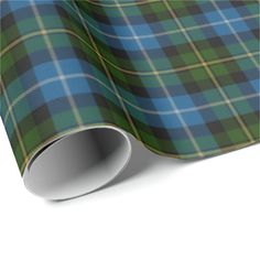 a green and blue tartan plaid wrapping paper on a white background with the image of a