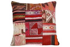 a multicolored patchwork pillow on a white background