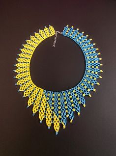 Beautiful bright yellow and blue necklace.Made of Czech beads Length 17.4 inches (44 cm) The width at the bottom of the necklace is 3 inches (7.5 cm) Chain to adjust the length of 2 '' (5 cm) Native Necklace, Beaded Collar Necklace, Necklace Trendy, Modern Necklace, Blue Beaded Necklace, Trendy Necklace, Beaded Rope, Beaded Collar, Long Drop Earrings