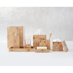 wooden boxes with soap, toothbrushes and other items in them on a white surface