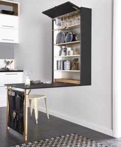 an open cabinet in the middle of a kitchen