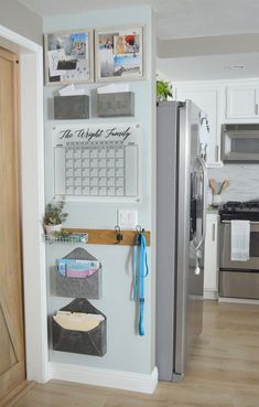 a refrigerator with magnets and pictures on the wall next to an open door in a kitchen