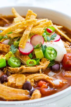 a white bowl filled with chicken tortilla soup