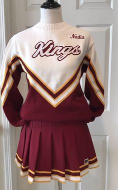 the maroon and white cheerleader uniform is on display