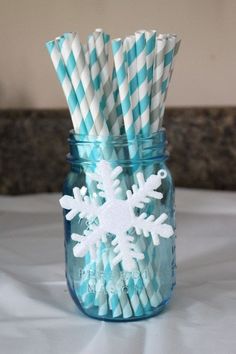 snowflake straws in a mason jar with blue and white striped paper straws