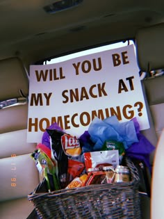 a sign that says will you be my snack at home coming? in the back of a car