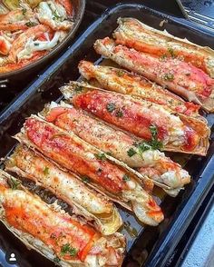 two pans filled with cooked lobster next to each other