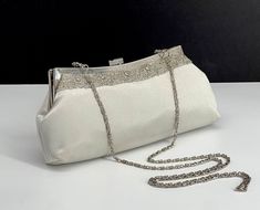 "Carlo Fellini Silver satin evening clutch with rhinestone and bead trim, silver metal frame and closure. Silver satin lining with pocket. 44\"L shoulder chain that can tuck away and an extra chain that can replace for wristlet. 10W 4.5H 2.5D" Formal Silver Beaded Evening Bag, Silver Beaded Evening Bag For Formal Occasions, Formal Silver Beaded Clutch, Silver Beaded Clutch For Formal Occasions, Elegant Silver Clutch For Dinner, Shoulder Chain, Beaded Trim, Evening Clutch, Clutch Handbag