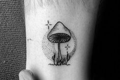 a small mushroom tattoo on the left inner arm, with water droplets coming out of it