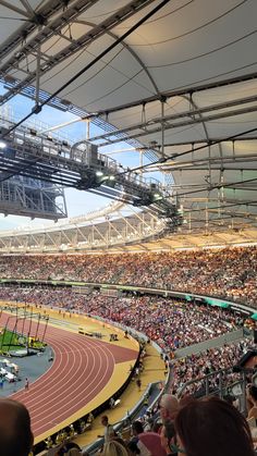 an indoor stadium full of spectators and runners