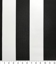 a black and white striped fabric is shown with a measuring ruler in front of it