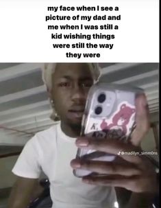 a person holding a cell phone in their hand with the caption, my face when i see a picture of my dad and me when i was still a kid wishing things were still there