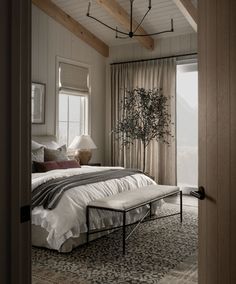 a bedroom with a large bed and wooden ceiling