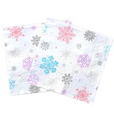 two napkins with snowflakes on them are sitting side - by - side