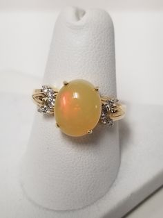 "Thanks for shopping our vintage estate store. We tend to sell well below wholesale and truly hope you enjoy all of our items. Many of the items are one of a kind, so please enjoy scrolling through the pictures and hopefully something will catch your eye. Brown spots are from the camera or reflections. Estate 14k yellow gold natural 4ct opal .20ct diamond ring. There are 10 diamonds, and they are nice and bright. Ring size: 7 Setting: 3/8\" 9mm by 11mm 1/2\" Gem: 9mm by 11mm Band width: 2mm Weight: 3.67 grams Opal appears to be 4ct and ring is marked 14k. Just stunning. As with most estate items there may be some wear on ring. We do not sell new rings, nor do we charge new retail prices." Brown Spots, Ring Size 7, Diamond Ring, Jewelry Rings, Opal, Pearl Earrings, Ring Size, Gems, Yellow Gold