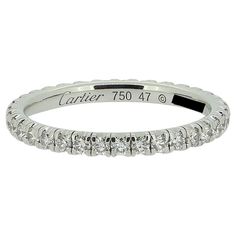 Here we have a classic diamond full eternity ring from the world renowned jewellery house of Cartier. The band has been crafted from 18ct white gold and plays host to 35 round brilliant cut diamonds; all of which have been individually claw set in a single line formation. As expected from Cartier the diamonds are perfectly matched in terms of colour, clarity and presence. Condition: Used (Excellent) - Professionally polished to appear brand new Weight: 1.5 grams Ring Size: I (47) Band Width: 2mm Total Diamond Weight: Approx. 0.40ct Diamond Details: Colour: F-G, Clarity: VVS-VS Marked: 'Cartier' '46' 'Au750' RRP: £5,200 Documents: Cartier Certificate of Authenticity Box: Cartier Ring Box Luxury Cartier Fine Jewelry Rings, Luxury Cartier White Gold Rings, Vintage Cartier Watch, Full Eternity Ring, Eternity Band Ring, Half Eternity Ring, Gold Band Ring, Modern Ring, Eternity Ring Diamond