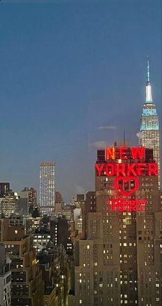 the new york city skyline is lit up in red and blue at night with skyscrapers