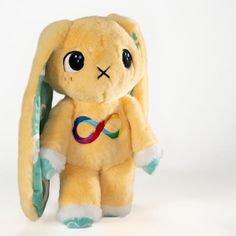 a yellow stuffed animal with a ribbon around its neck and eyes, on a white background