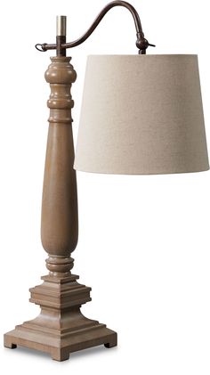 a wooden table lamp with a beige shade