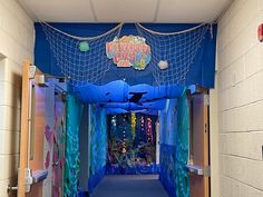 the hallway is decorated with blue and green decorations for an underseam birthday party