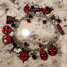 a bracelet with deadpool charms on it