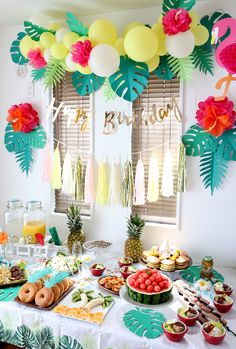 a tropical themed birthday party with food and decorations