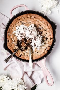 a skillet filled with cookies and marshmallows on top of a table