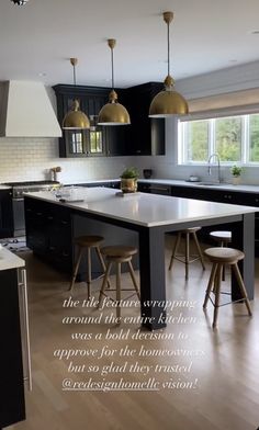 a large kitchen with black cabinets and white counter tops is featured in the ad for an interior design magazine