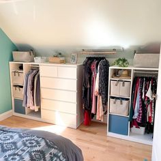 a bedroom with blue walls and white drawers