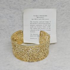 Stunning Metropolitan Museum of Art floral openwork bracelet. The open cuff measures 6" and 1.25" wide and electroplated with 24 karat gold. This bracelet is derived from the harmonious combination of bold floral motif and rhytmic foliate scrolls. In great condition. Contact me with any questions.  Note: Image colors may vary based on computer resolution. Measurements are approximate Ornate Gold Filigree Cuff Bracelet, Ornate Gold Cuff Bracelet With Filigree, Ornate Gold Cuff Bracelet With Intricate Design, Gold Filigree Cuff Bracelet As Gift, Note Image, 24 Karat Gold, Cuff Bangle Bracelet, Wide Cuff, Cuff Bangles