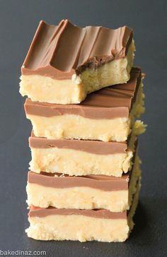 four pieces of chocolate and peanut butter bars stacked on top of each other with one slice missing