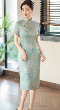 Indulge in the exquisite elegance of this green Cheongsam dress. Featuring a delicate flower print and a traditional mandarin collar, this dress is adorned with two subtle side slits, creating a timeless and sophisticated silhouette, perfect for any special occasion. Size Guide: Please refer to the size guide picture before placing the order. Please leave your Height, Weight and Bust measurements in the Personalisation box so we could double check the size for you. Spring Green Cheongsam With Stand Collar, Green Stand Collar Cheongsam For Spring, Green Elegant Cheongsam With Stand Collar, Elegant Green Cheongsam With Stand Collar, Green Dresses For Tea Ceremony, Elegant Green Ao Dai For Summer, Light Green Fitted Dress With Short Sleeves, Fitted Floral Print Cheongsam With Short Sleeves, Fitted Short Sleeve Floral Cheongsam